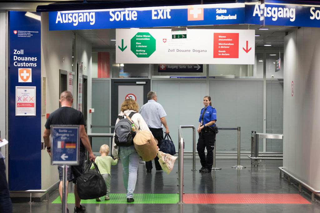 Passengers and border guard at airport Basel Mulhouse