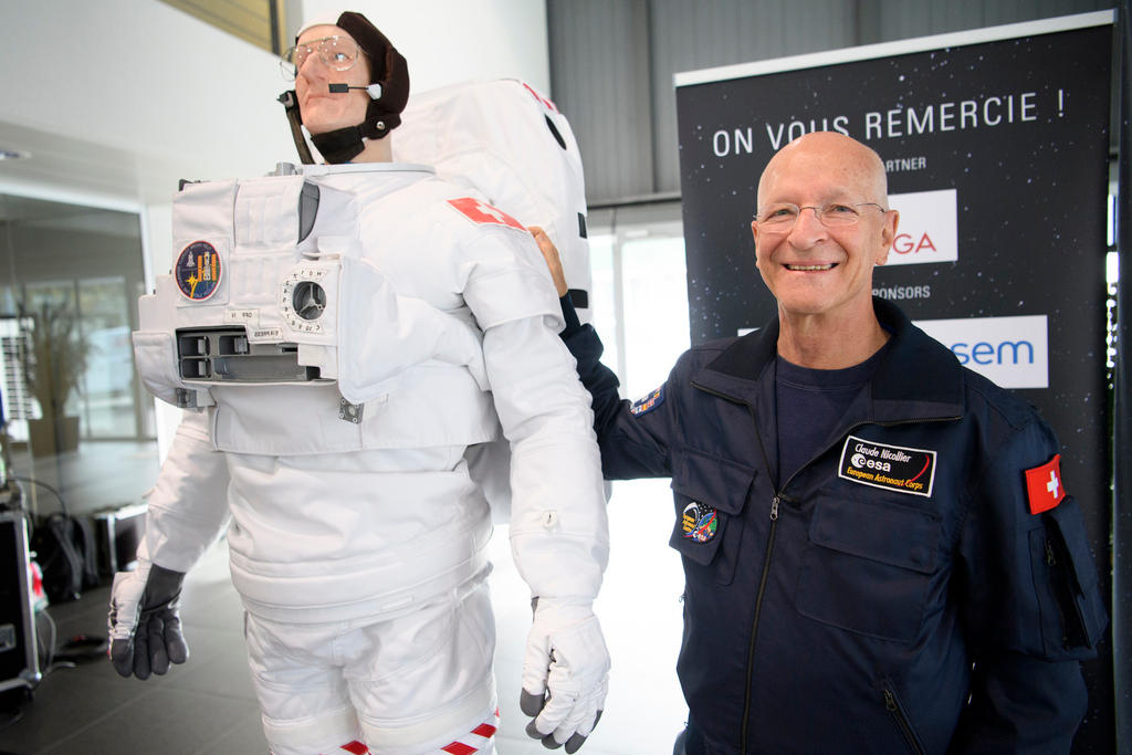 man next to astronaut doll