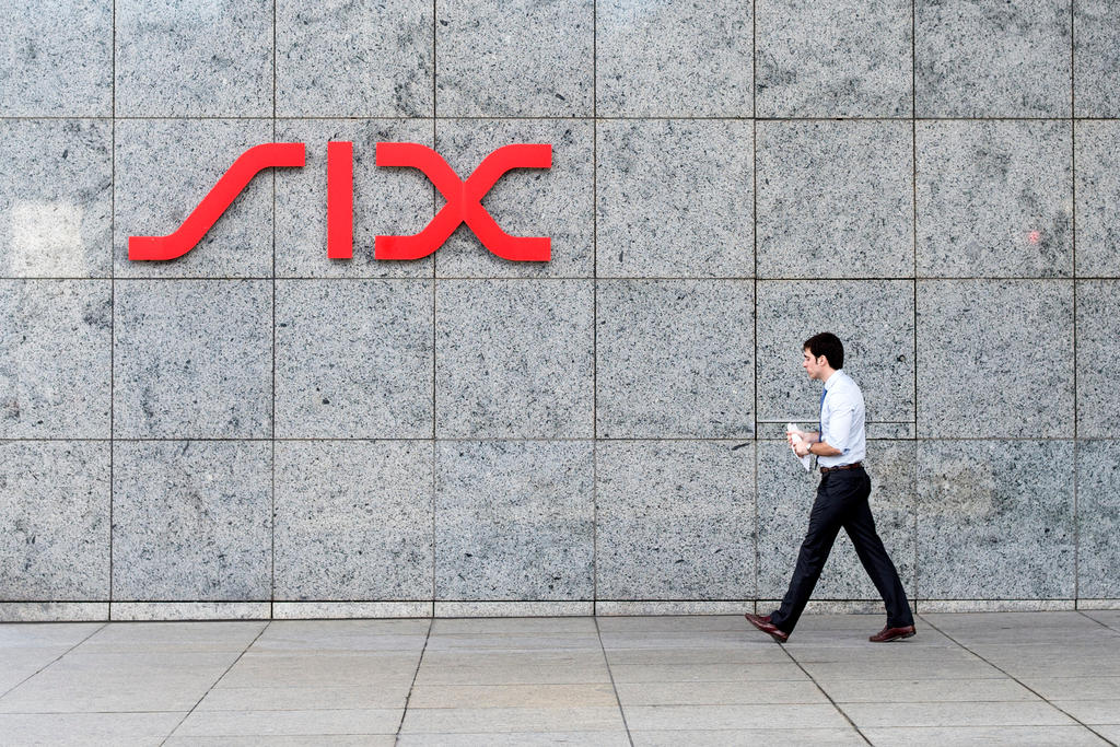 A man walks past a SIX sign