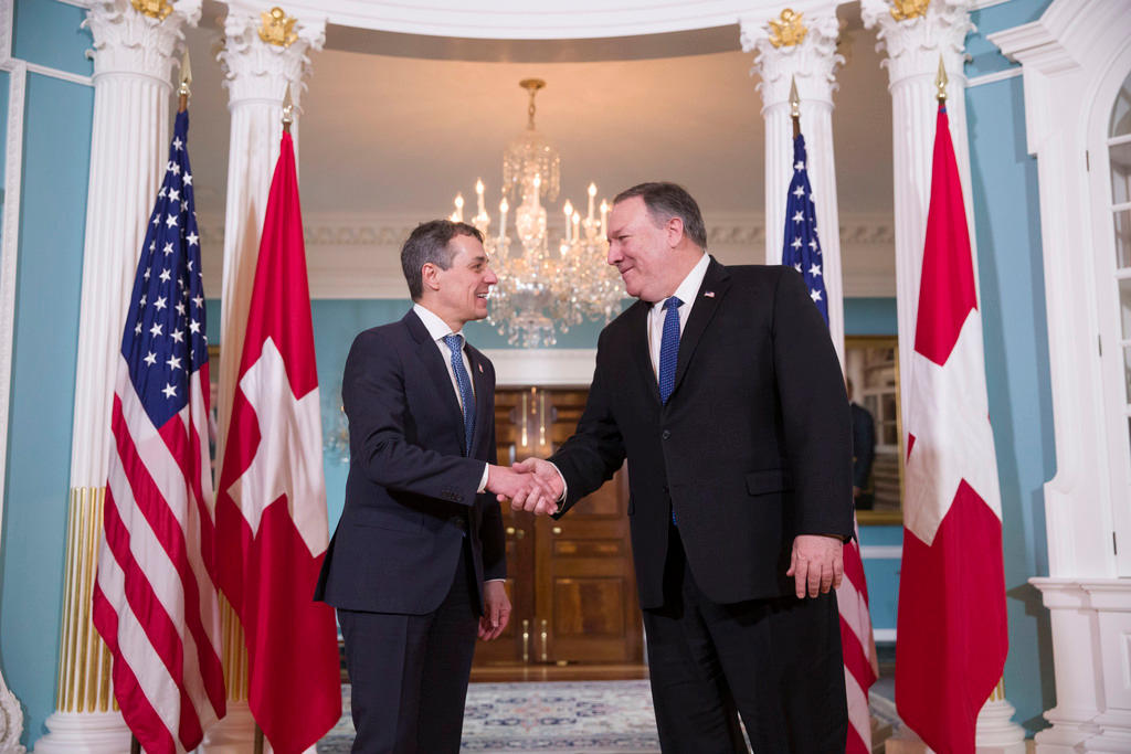 Swiss Minister of Foreign Affairs Ignazio Cassis, left, shakes hands with US Secretary of State Mike Pompeo