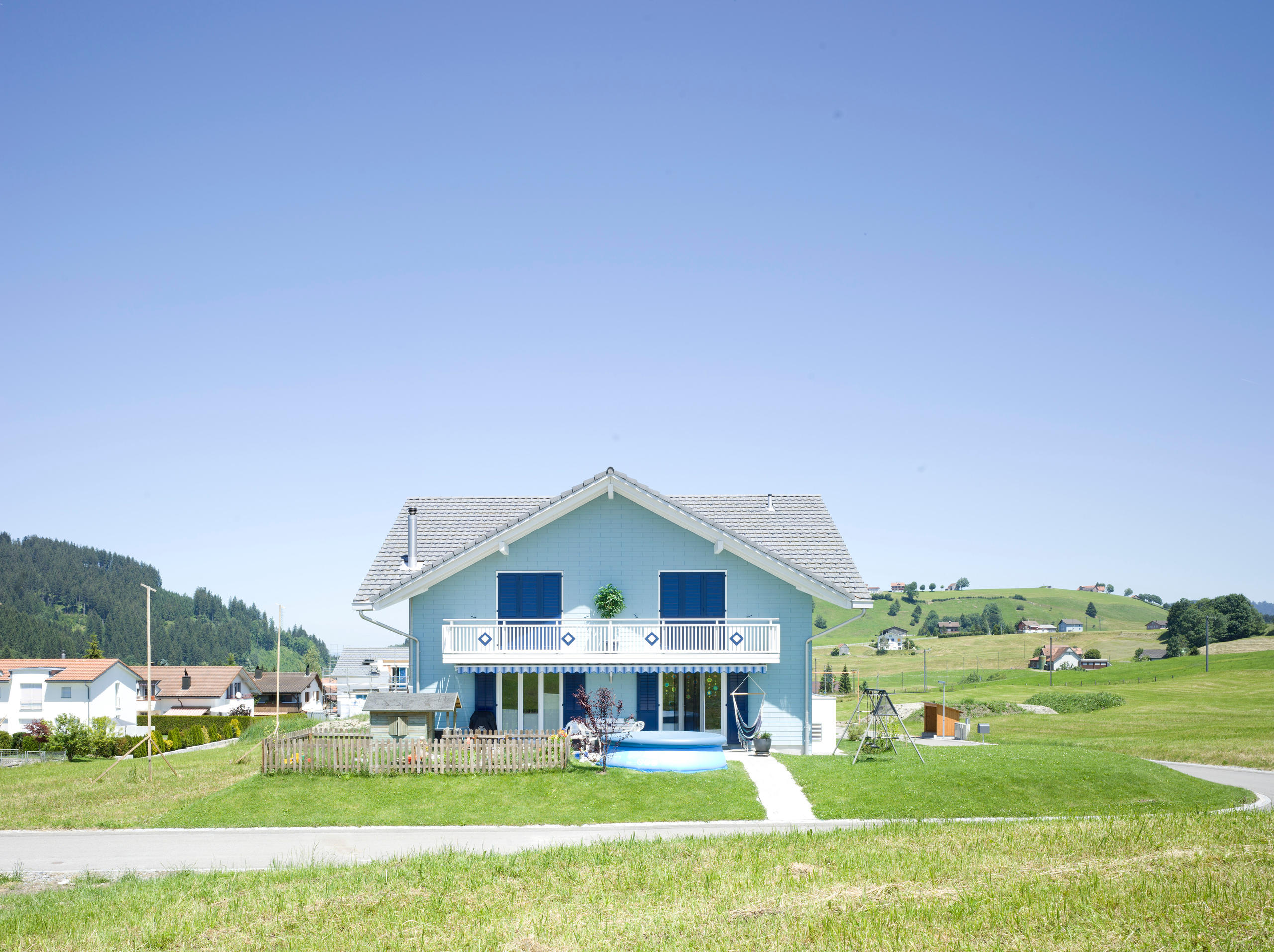 Typical single detached house in a hilly area in central Switzerland