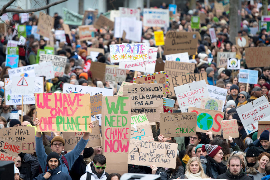 demonstrators march through Lausanne with banners for the climate
