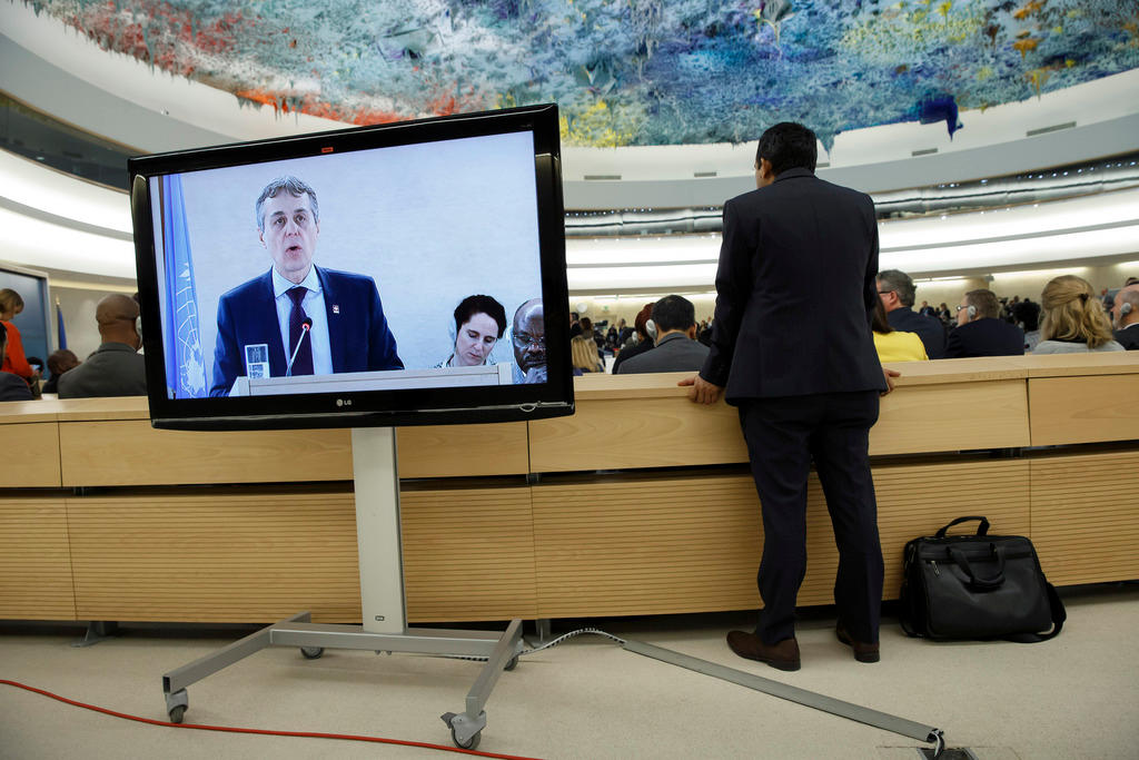 Swiss foreign minister Cassis on TV screen in chamber of the Human Rights council