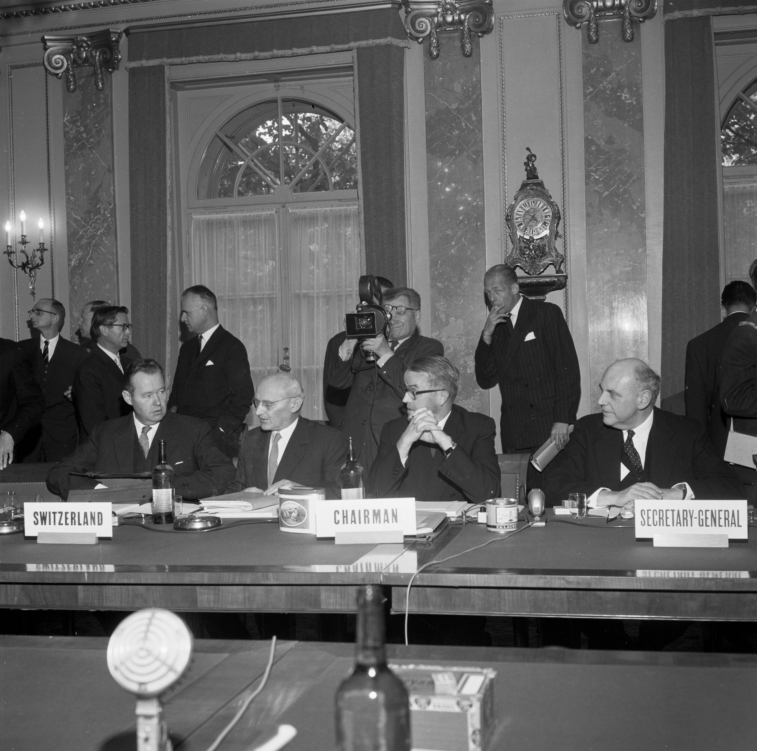 Hombres sentado en torno a una mesa durante una conferencia