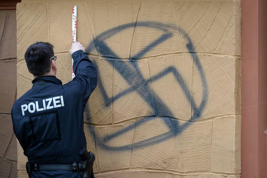 police and crossed out swastica