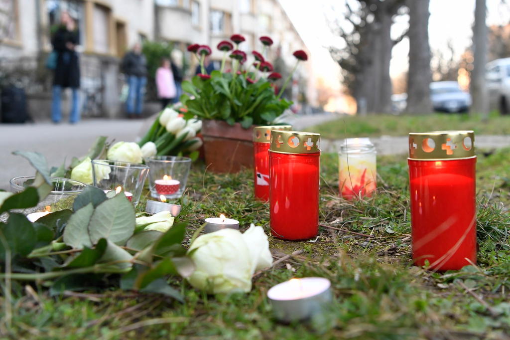 Flowers on the sidewalk where a seven-year-old boy was stabbed