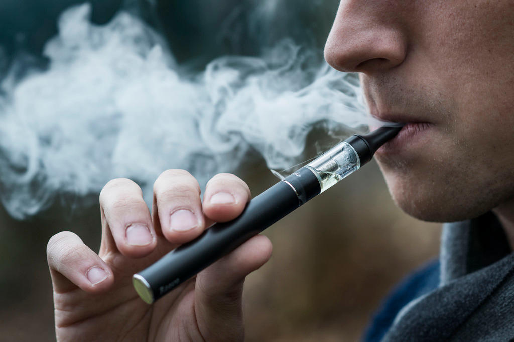 uomo fuma una sigaretta elettronica