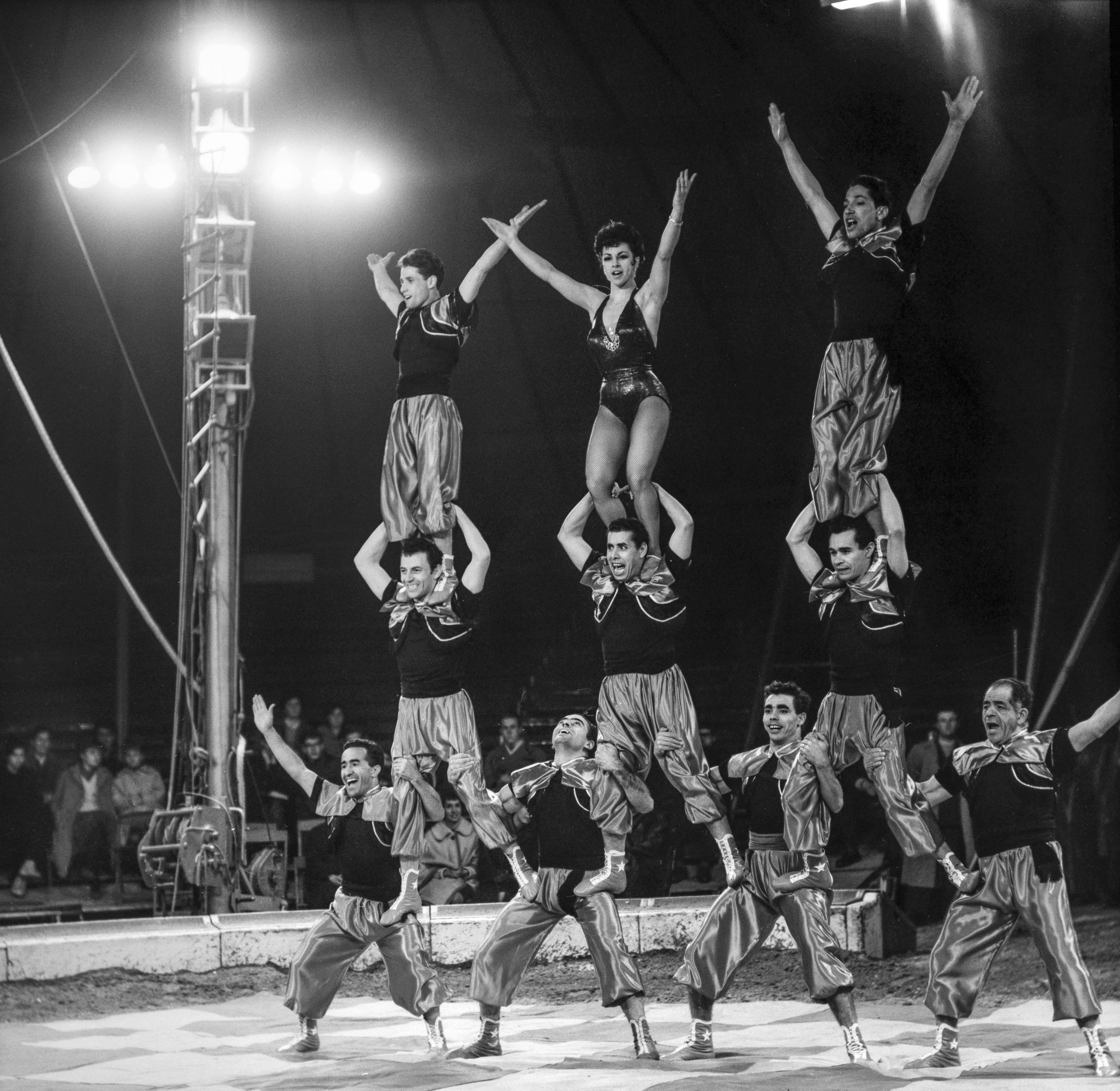 Ten performers form a human pyramid
