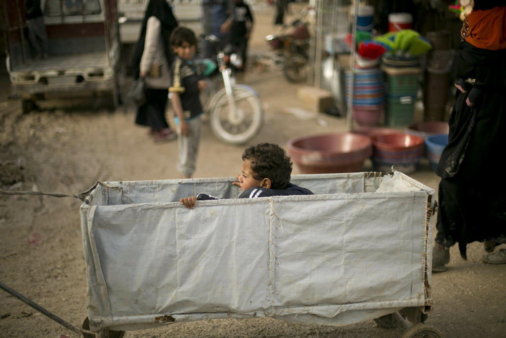 A child rides in a makeshift cart at Al-Hol camp in Syria on March 31, 2019