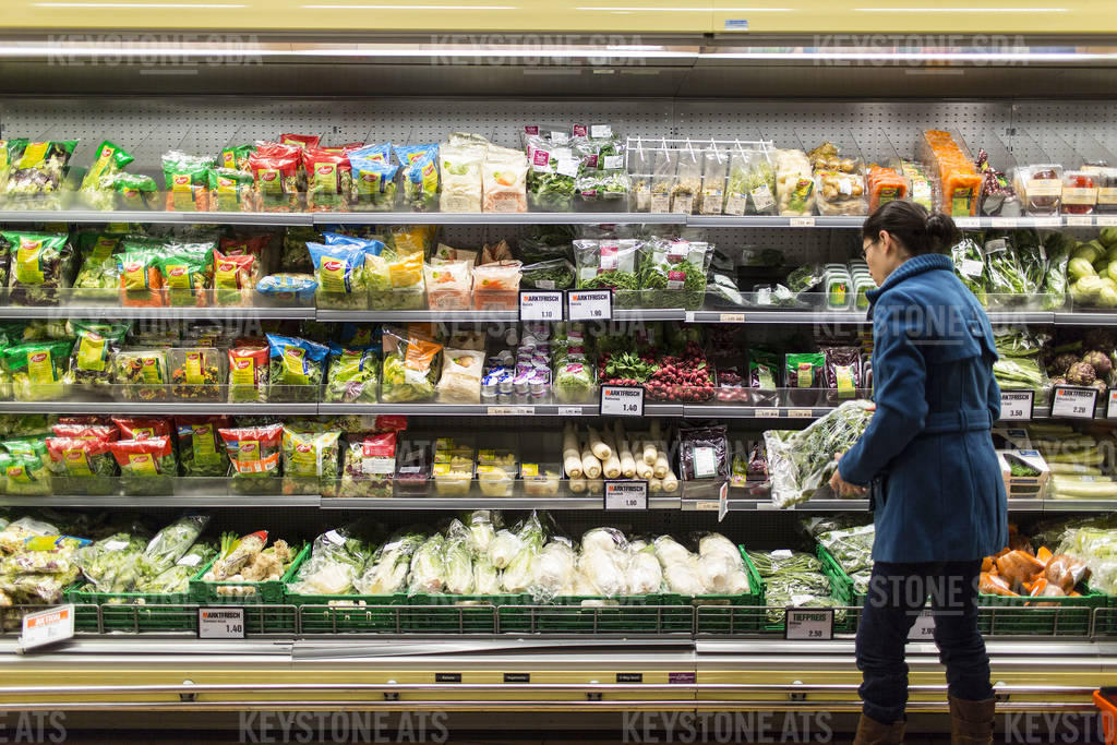 A woman buys groceries from a supermarket