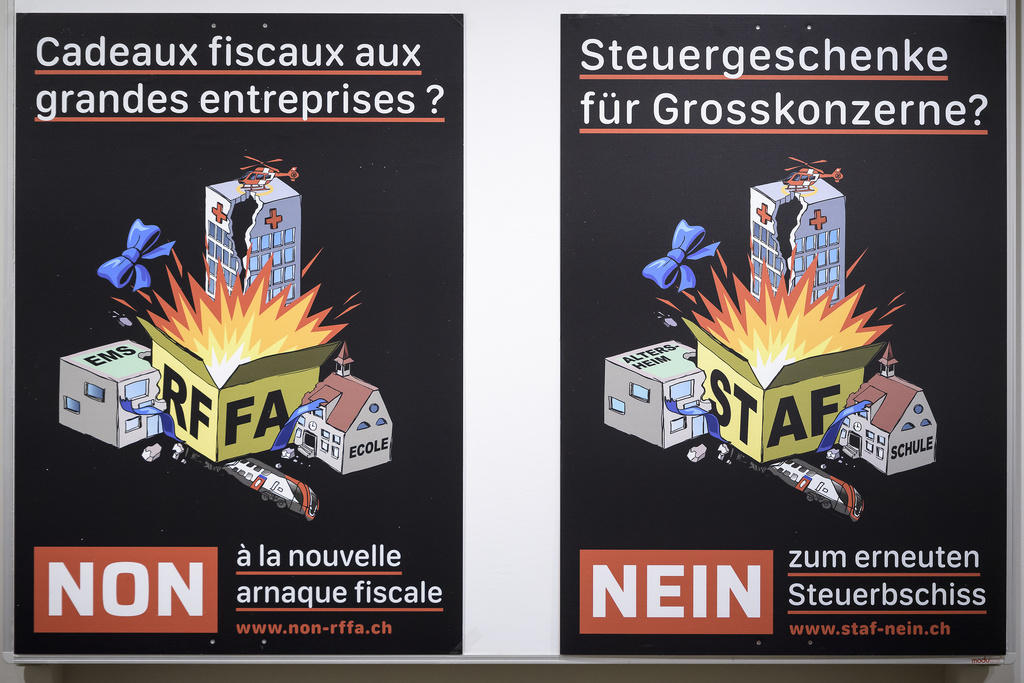 L affiche du non à la RFFA avec un paquet qui explose au milieu de bâtiments, un école et un EMS