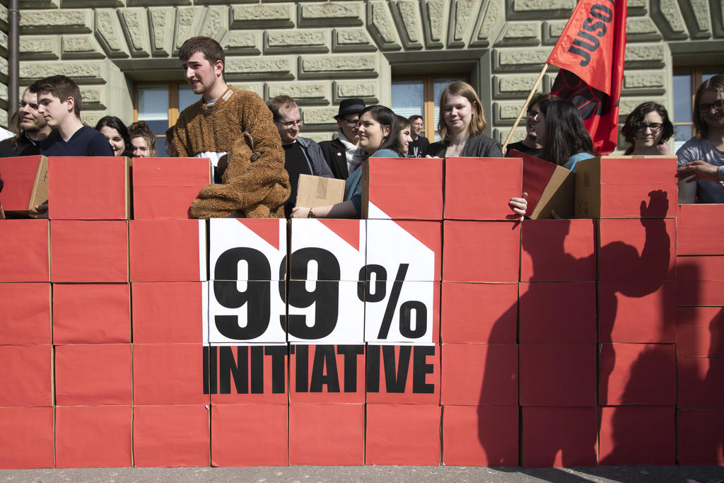 Committee members of 99% initiative behind a wall of boxes containing signatures