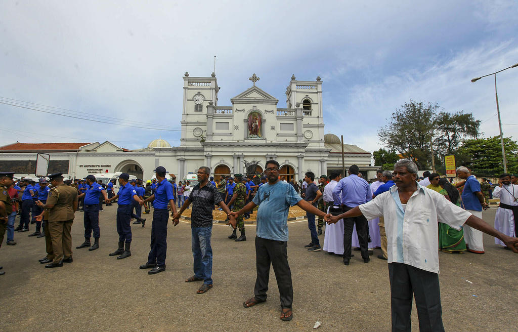 people holding hands in front of a church