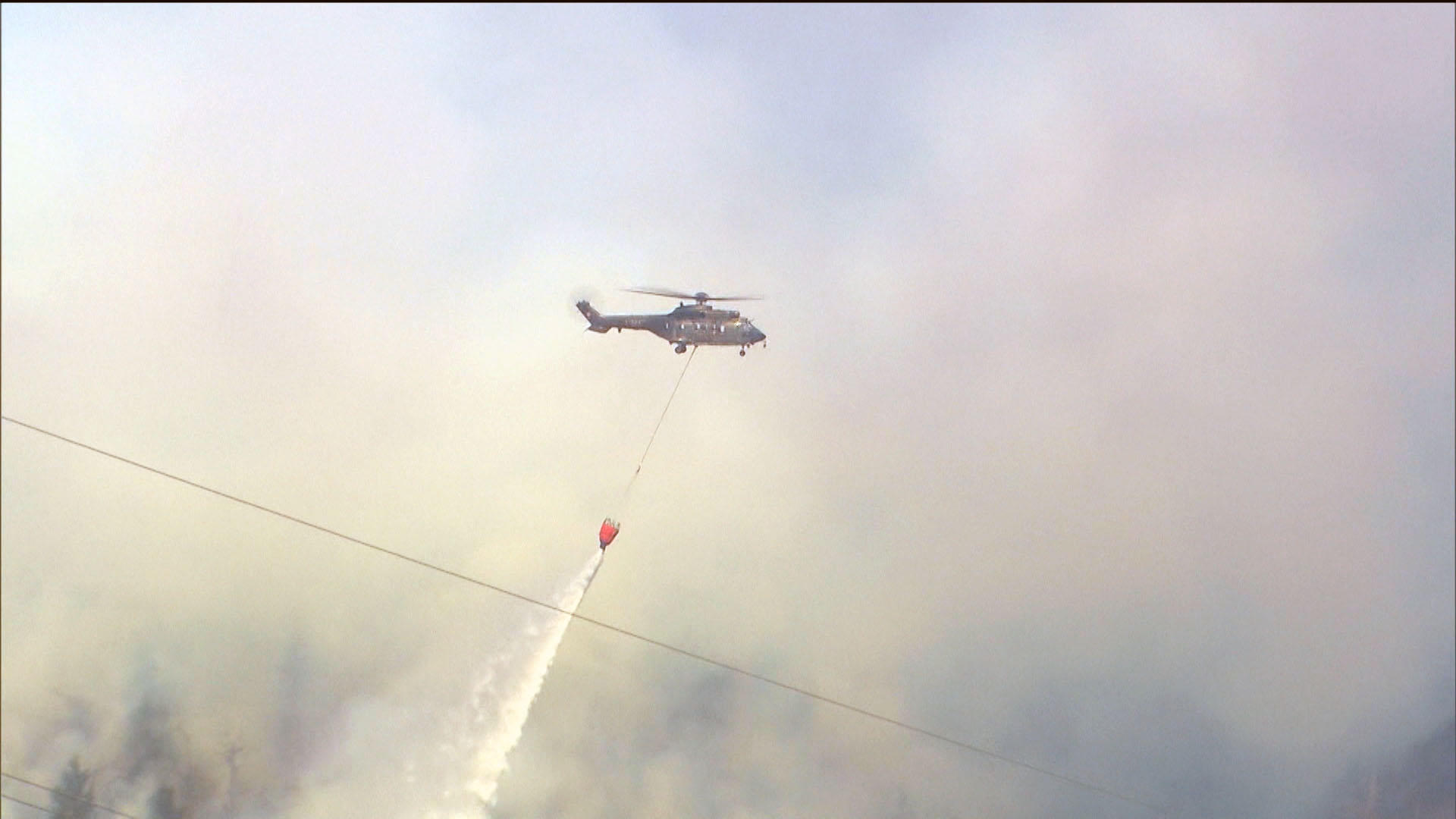 Helicopter putting out a forest fire