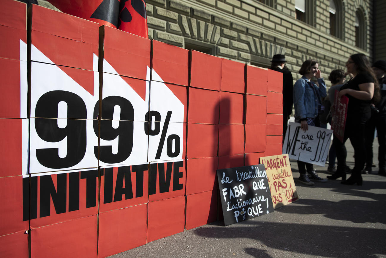 cartoni rossi su cui sta scritto iniziativa 99%