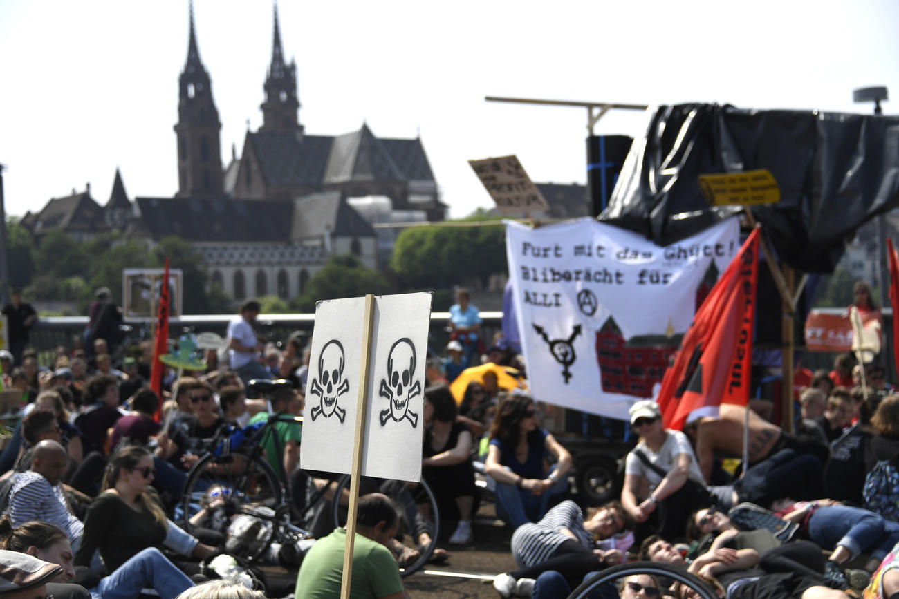 Protestors carry banners during a march against chemical companies in Basel