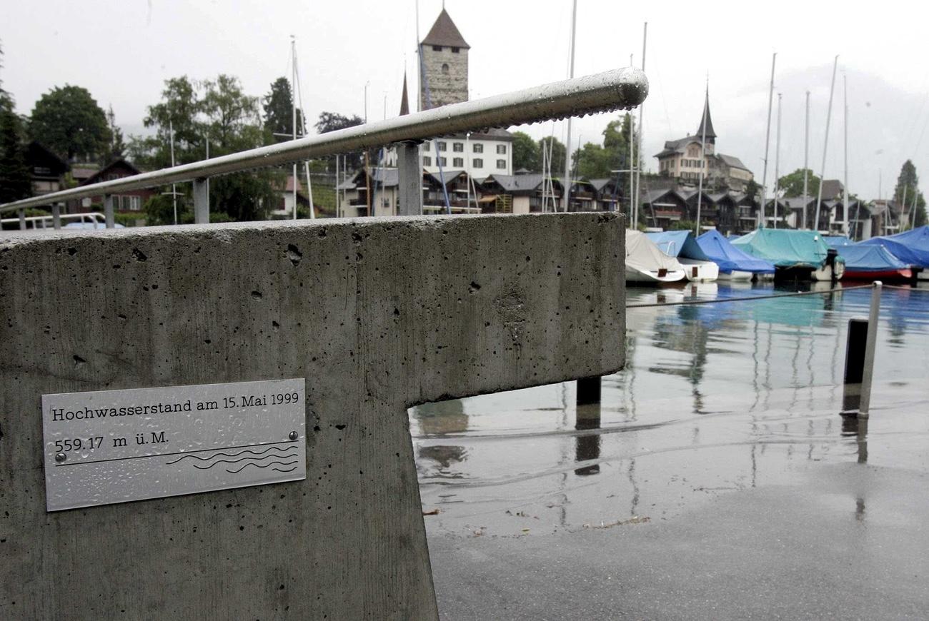 A plaque shows the high water mark of the flood of 1999, at the side of a yacht harbour