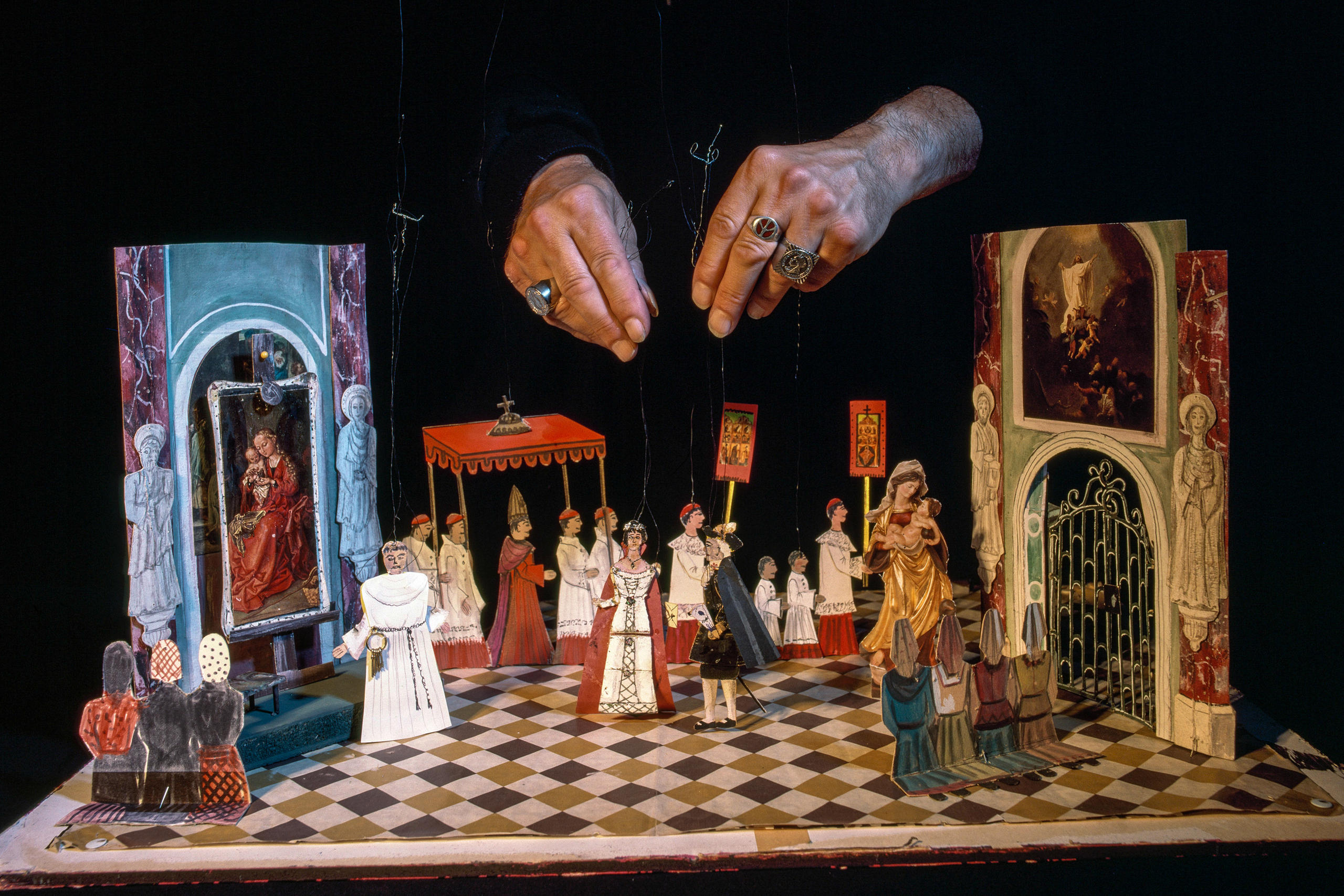 tiny setting from opera with hands of puppeteer