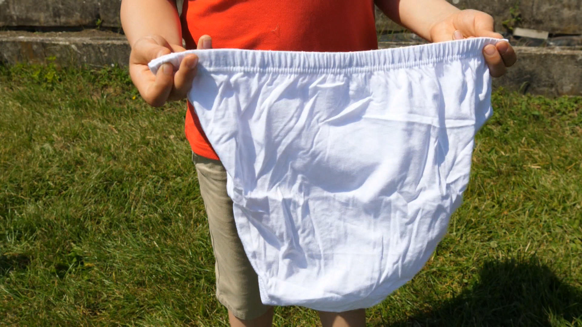child holding large pair of undies