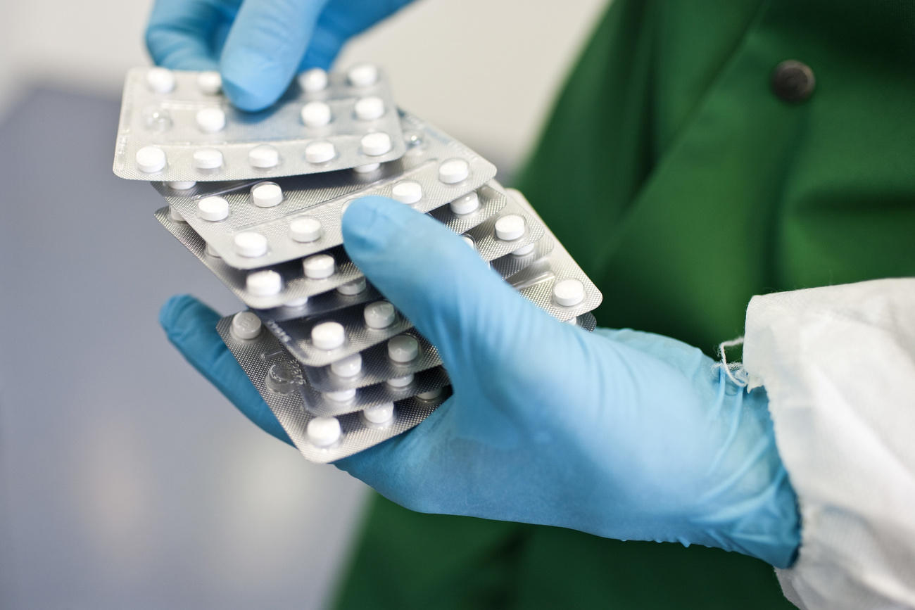 Person holding packets of medicaments