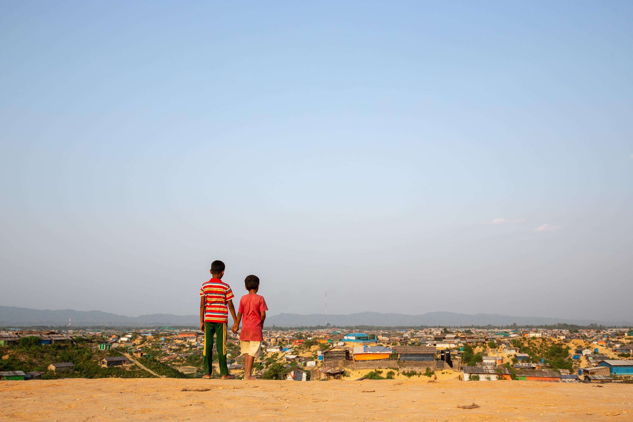 طفلان من الروهينجا يطلان على أكبر مخيم للاجئين في العالم.