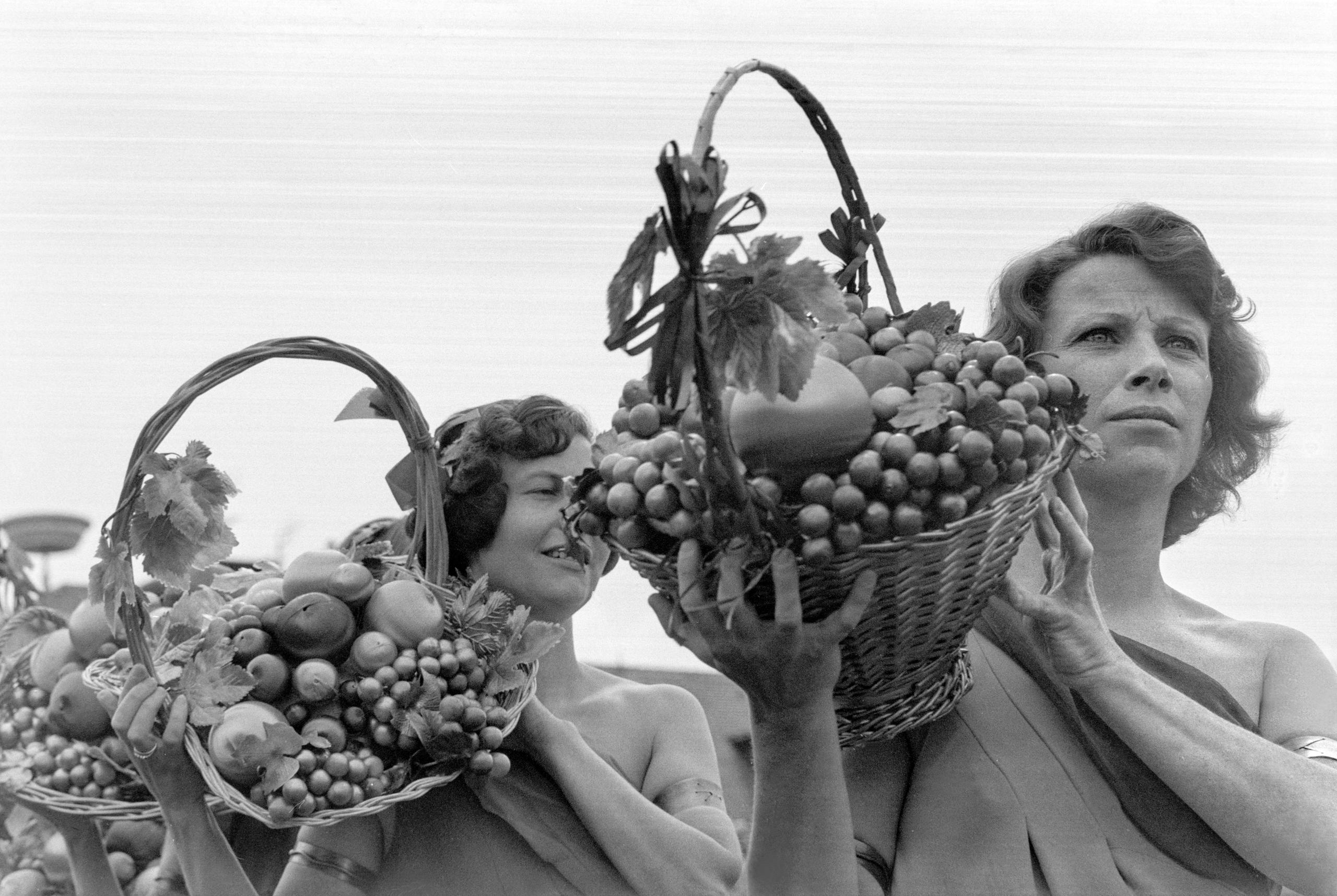 women carrying grapes