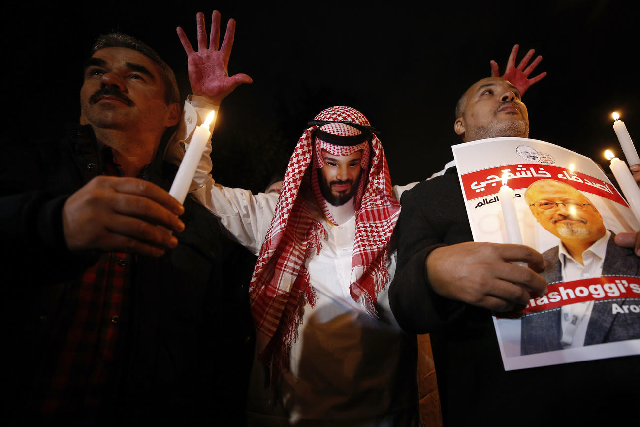 Protester holding up image of Saudi crown prince with bloody hands at a vigil for slain journalist Khashoggi