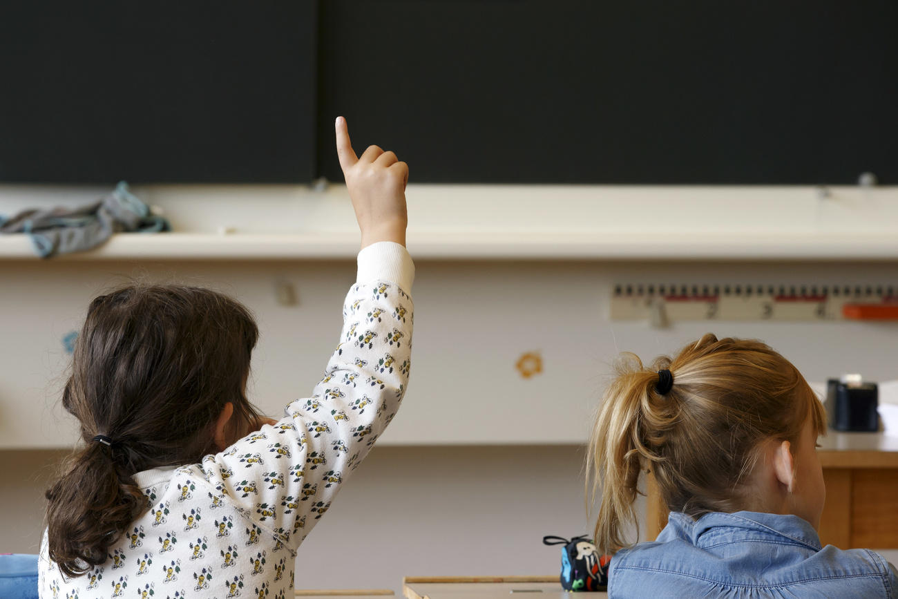 child raises hand in class