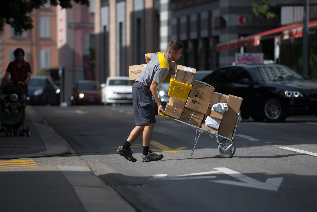 postal worker laden with parcels
