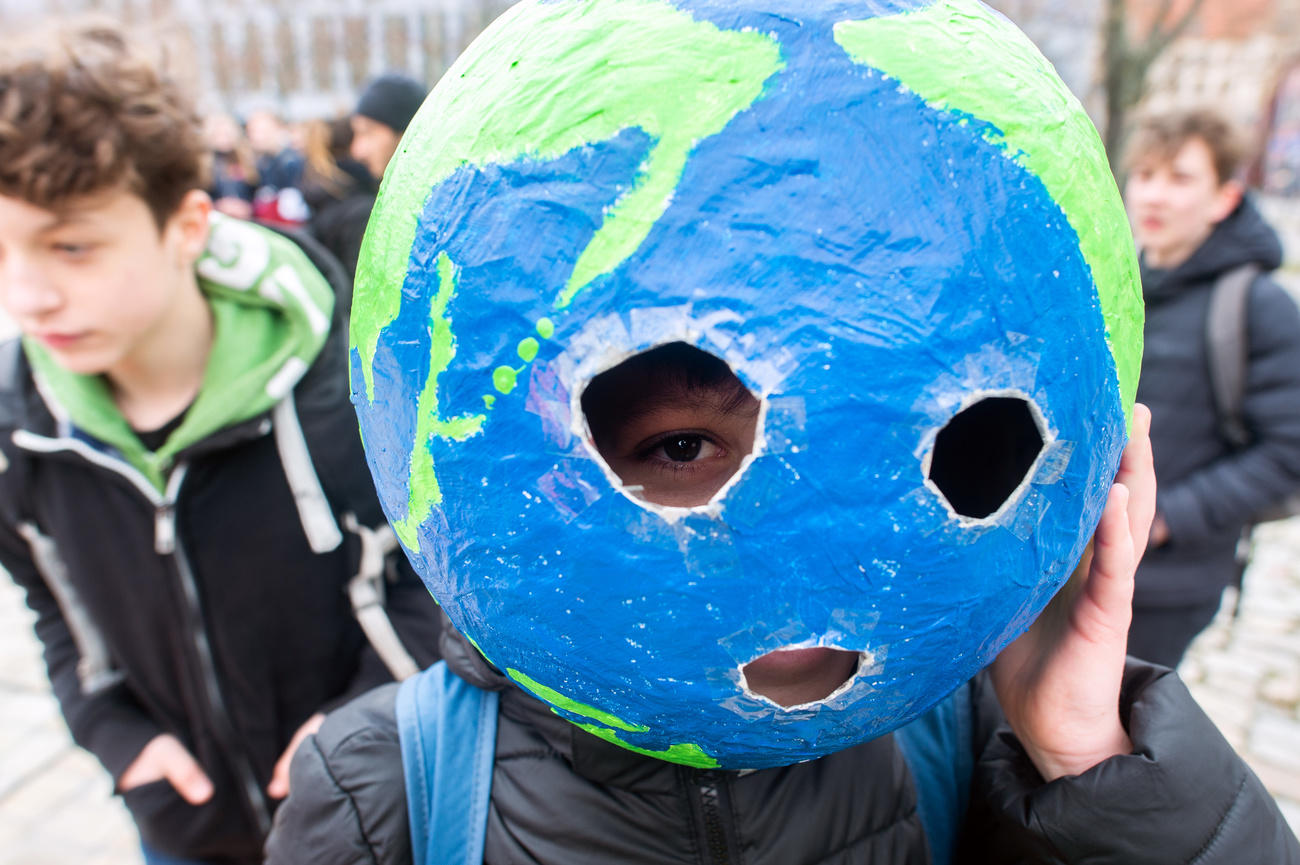 Child with globe on head