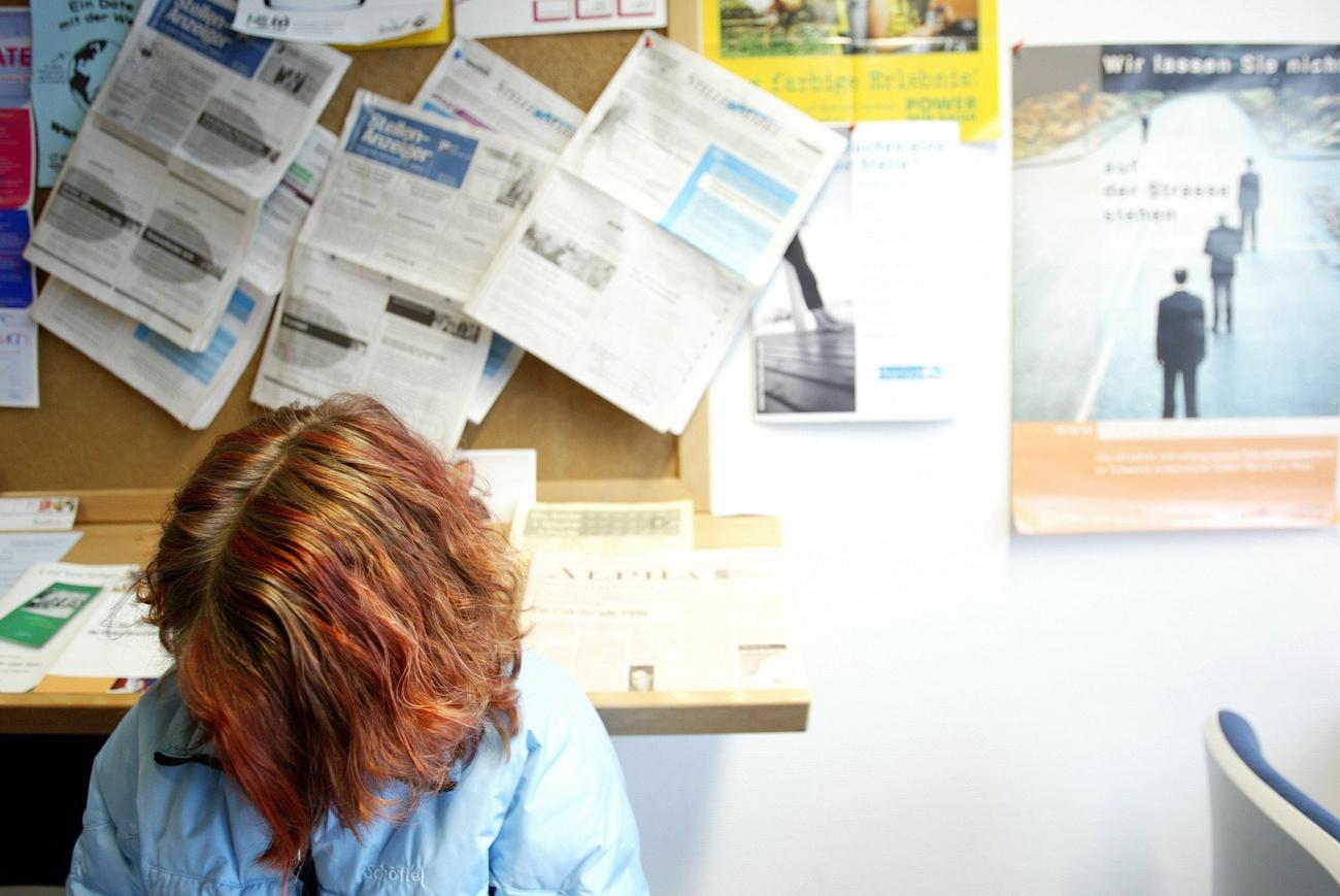 A young woman looking for a job sits in the waiting room at the regional employment service center, RAV