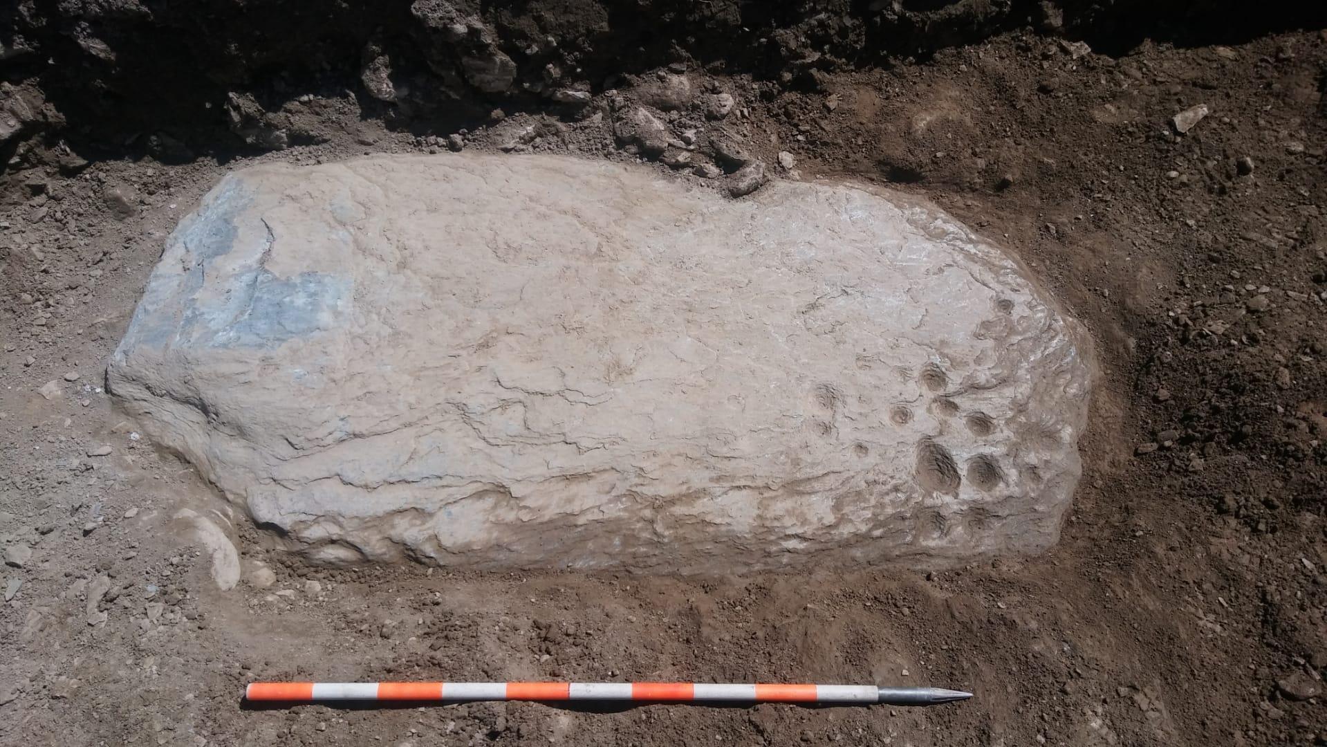 stone with small circular depressions
