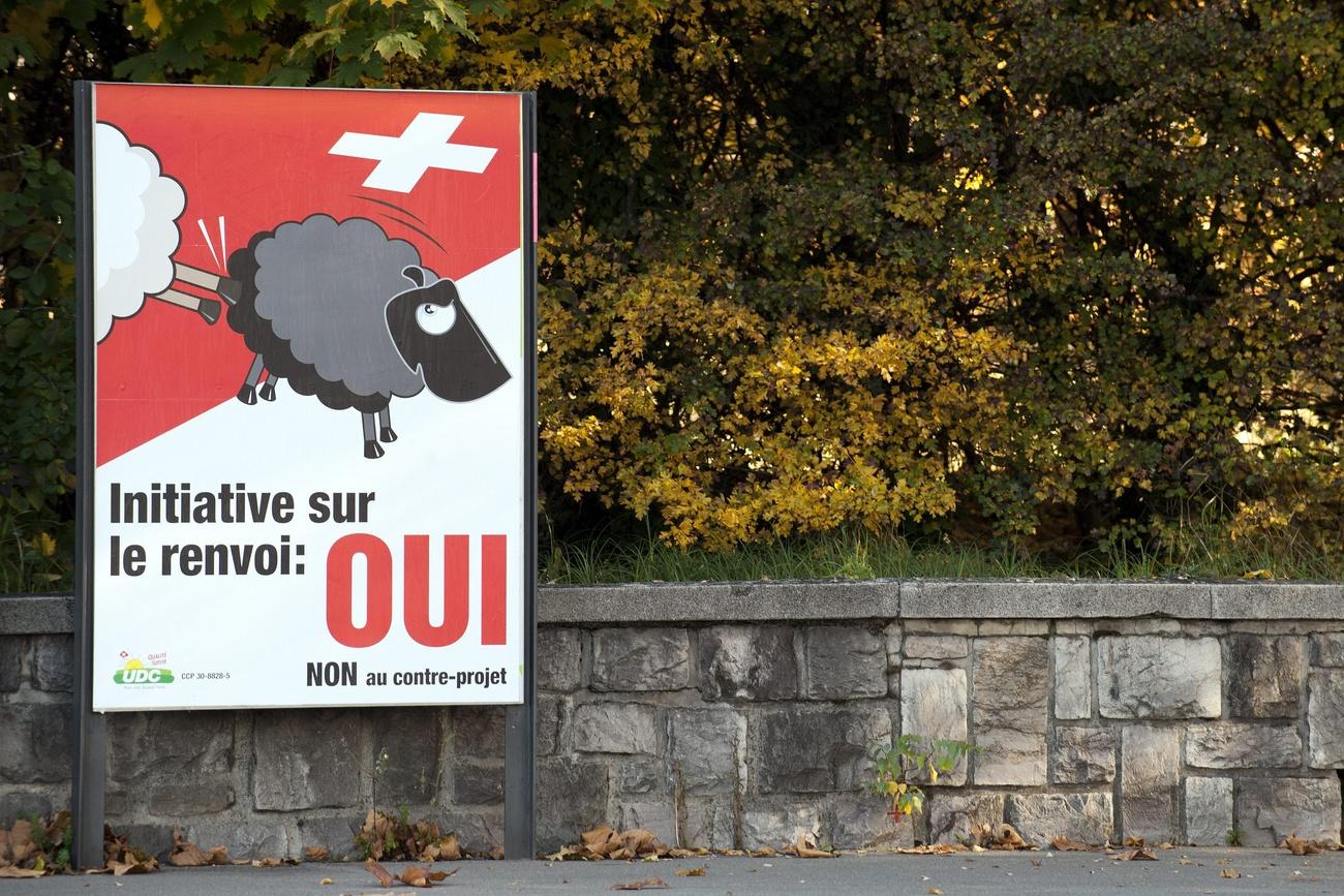 Campaign poster of white sheep kicking black sheep