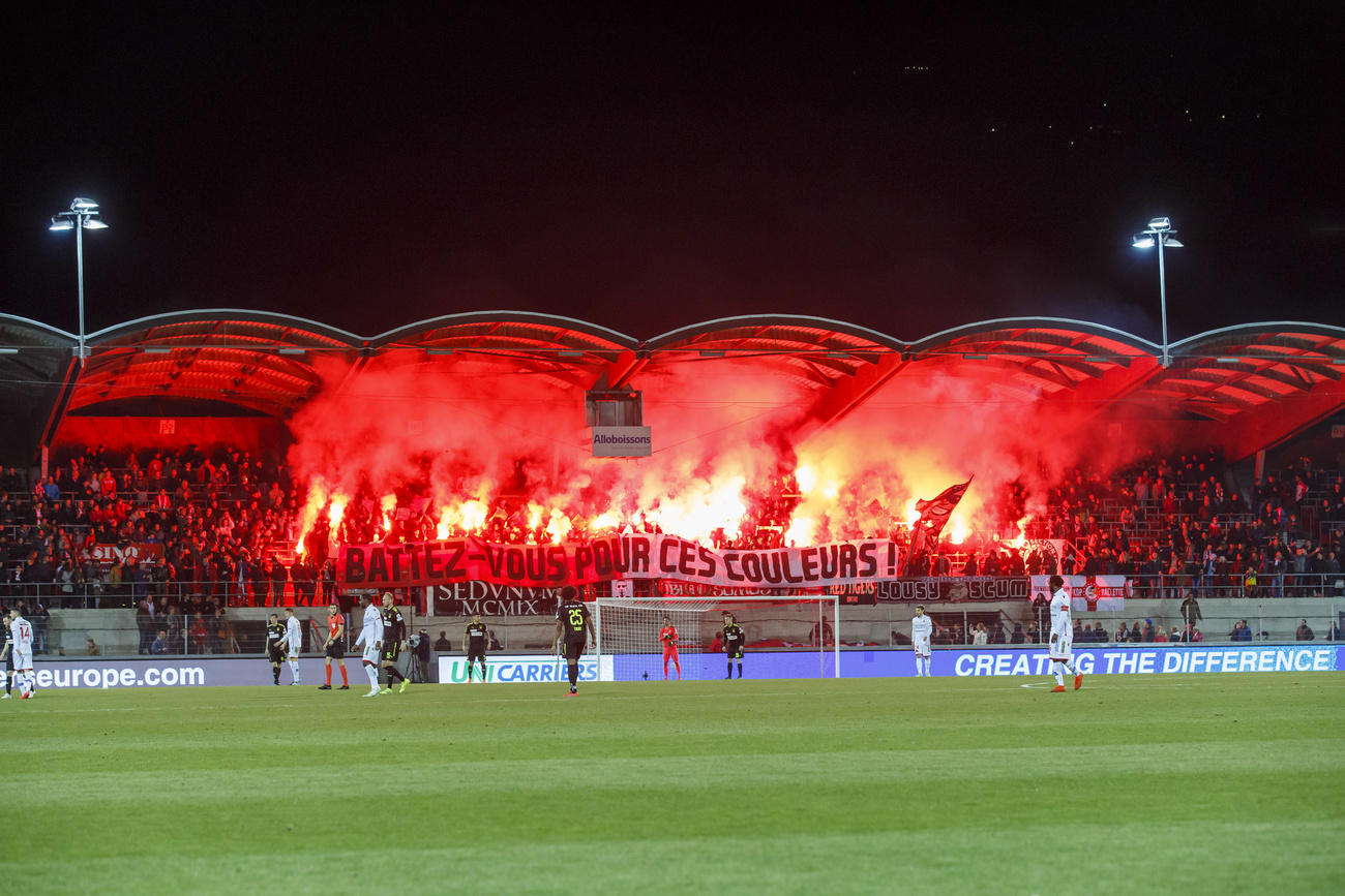 Supporters light smoke flares at a Swiss football match