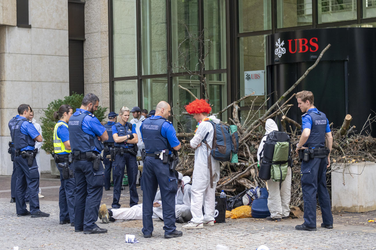 Police checking environmental protesters outside a UBS bank building in Basel