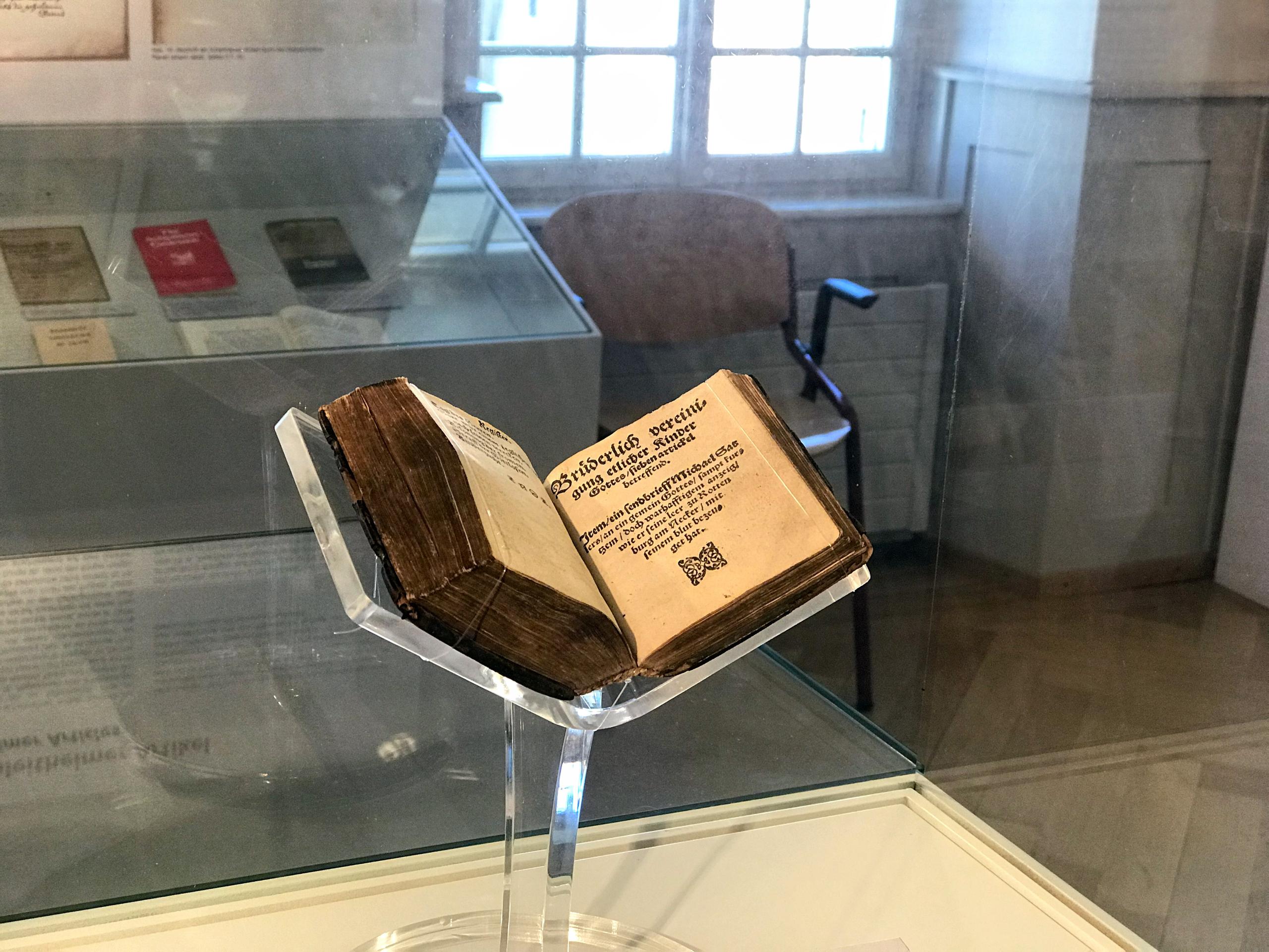 Old book on display in exhibition room of museum