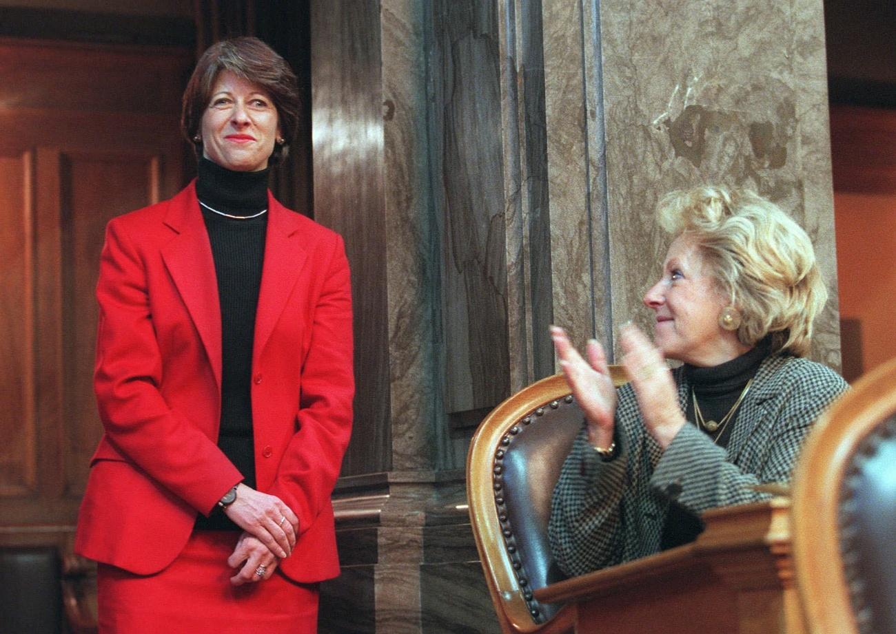 Huber-Hotz (left) and a Senator applauding her
