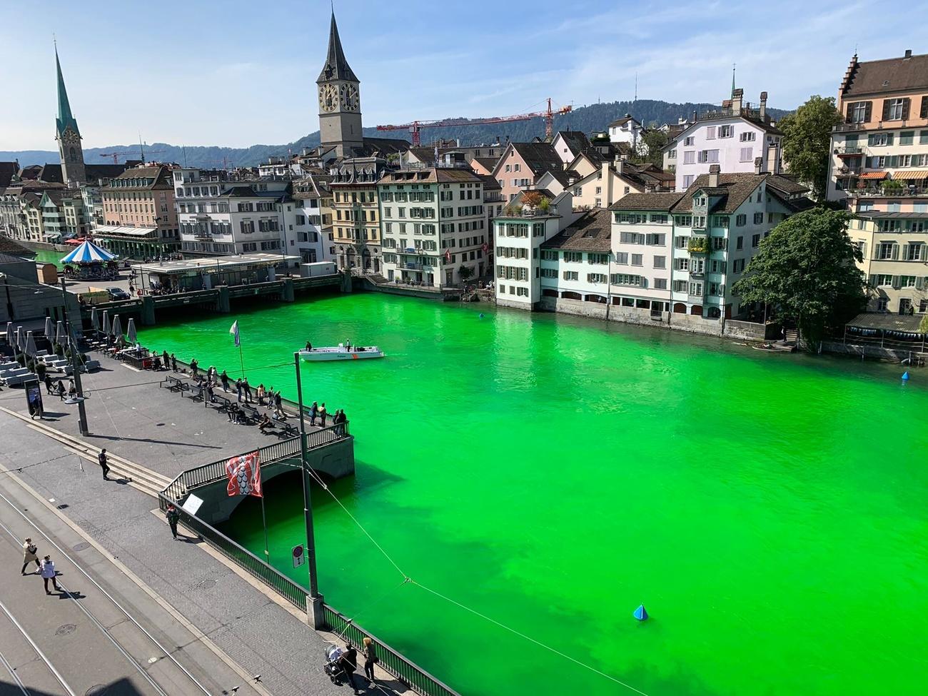 Around 30 demonstrators floated down the bright green river between the Münster and Rathaus bridges on Tuesday in protest.
