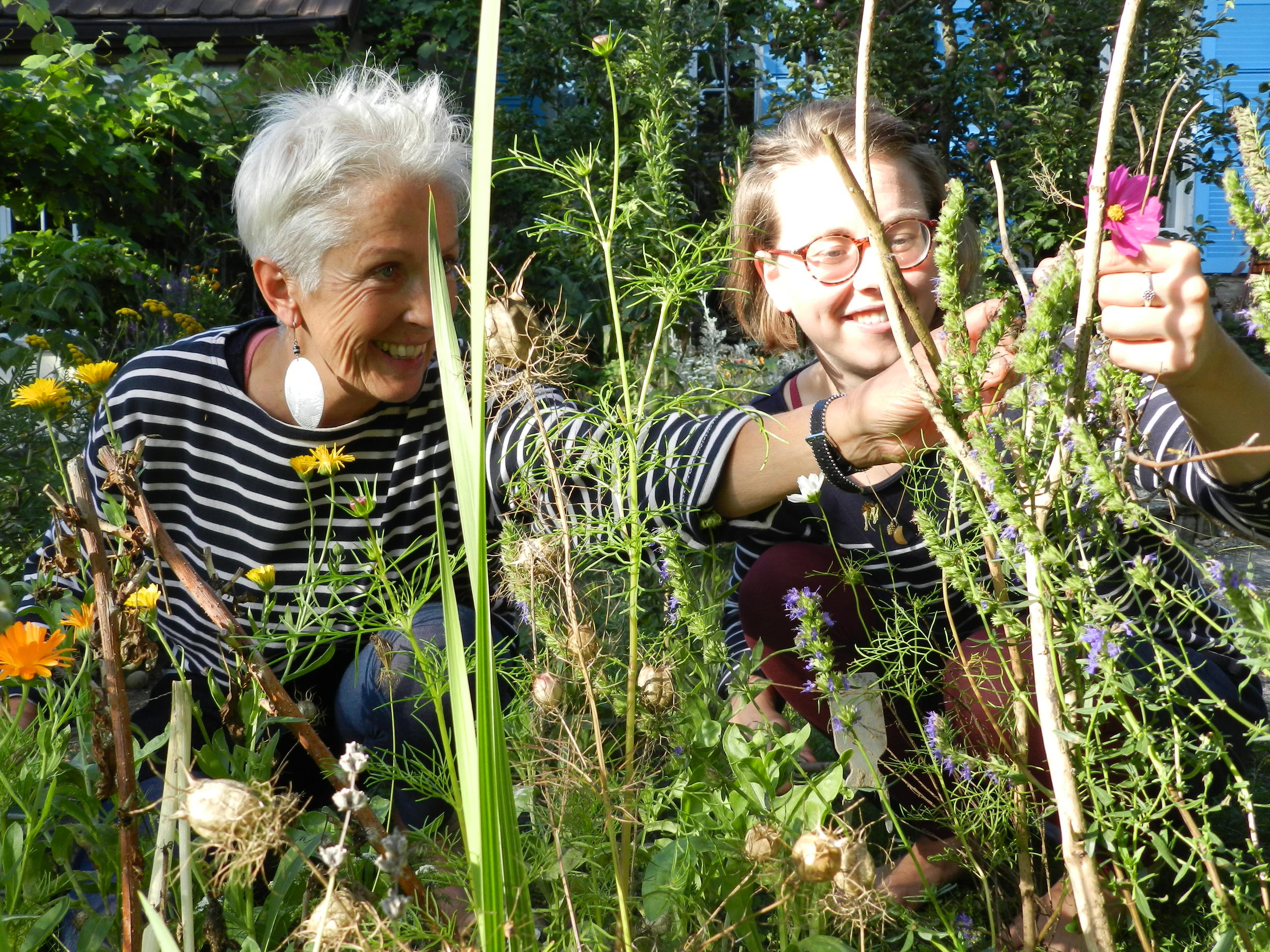 Two women gardening with smiles