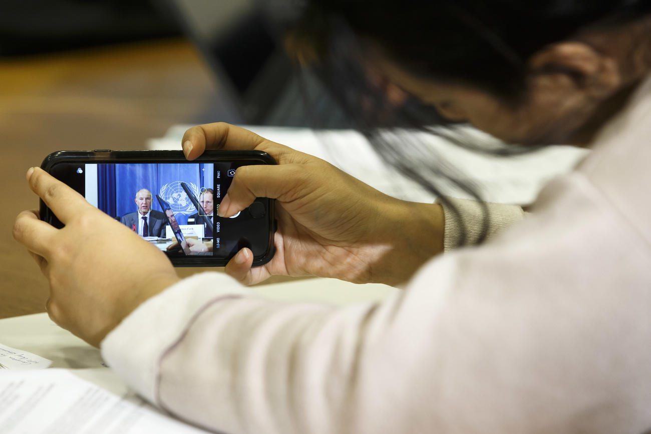Journalist taking a picture with a mobile phone