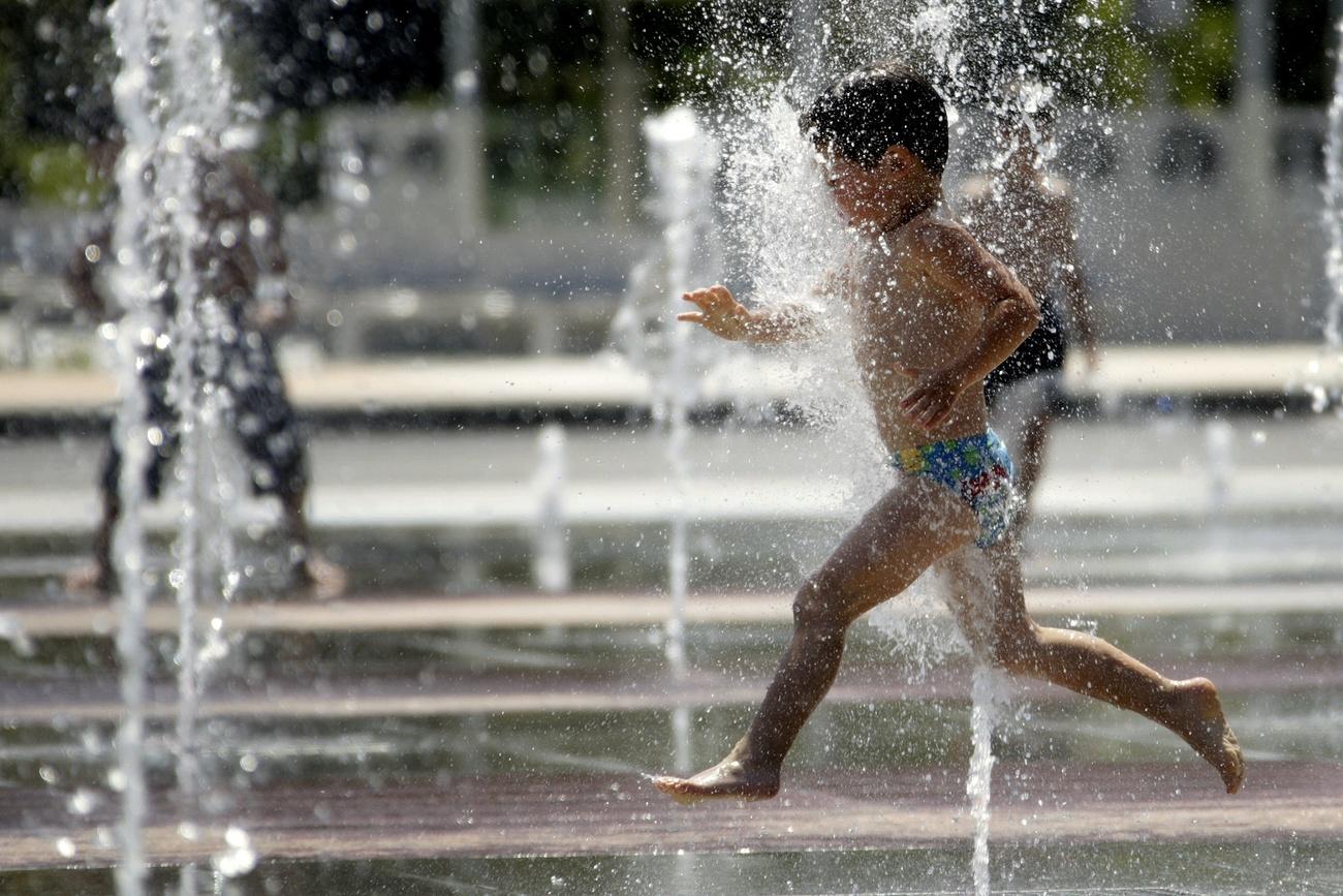 child running through fountain