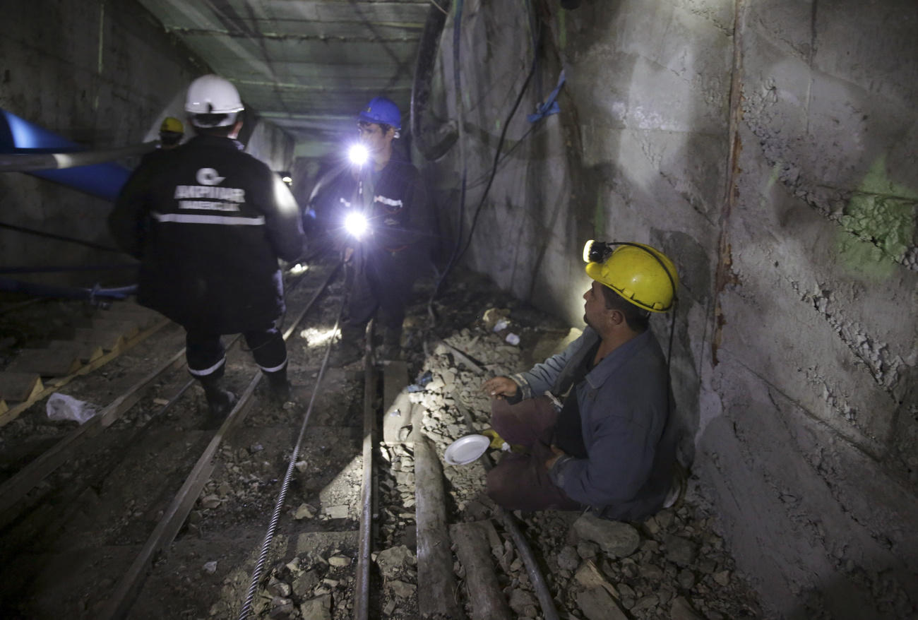 rescue workers fixing underground water pipes