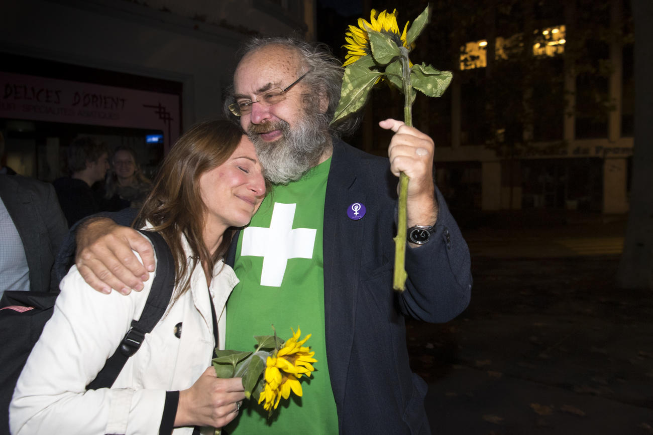 Man in Green t-shirt and woman holding sunflowers