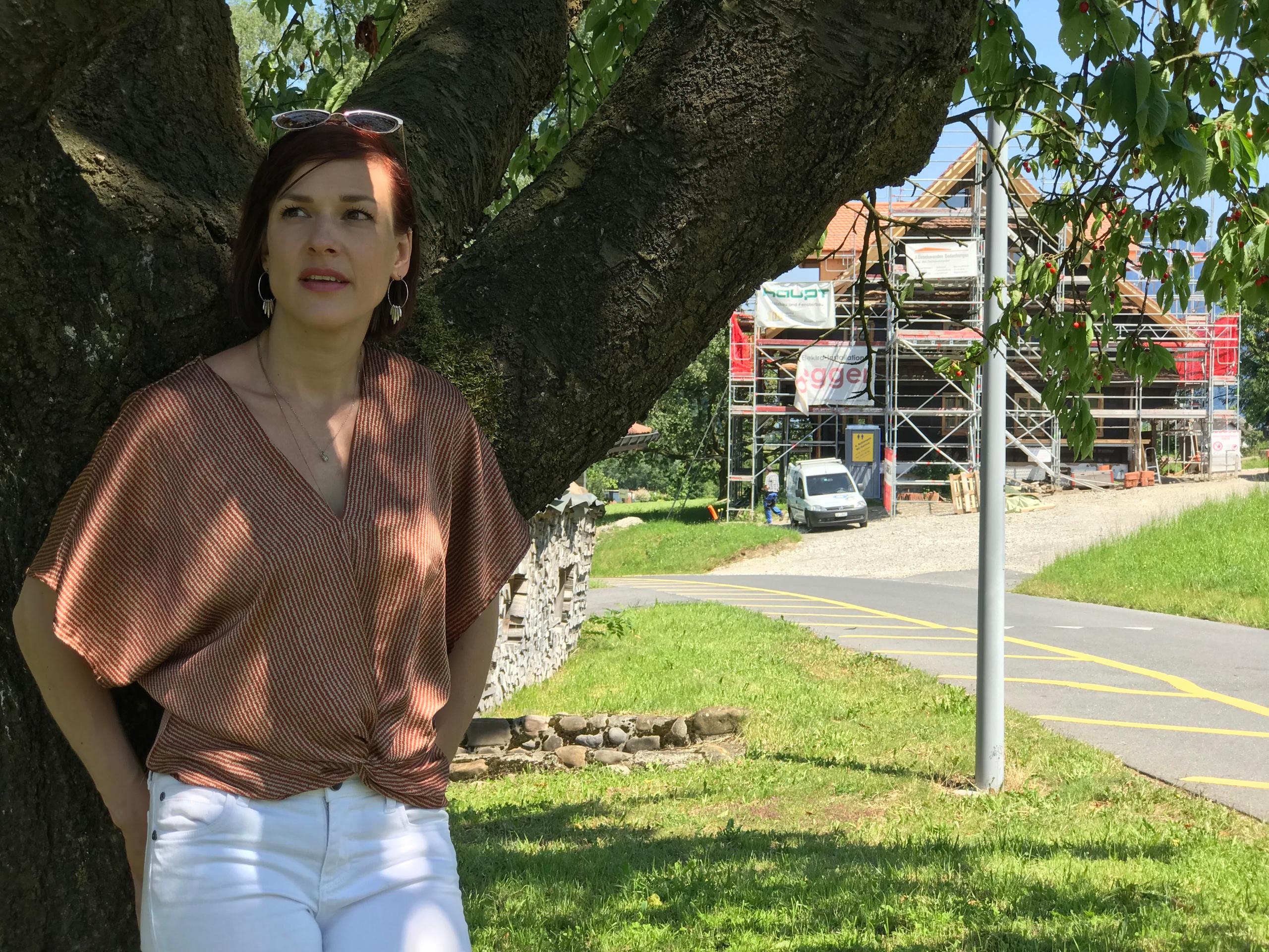 woman leaning on tree