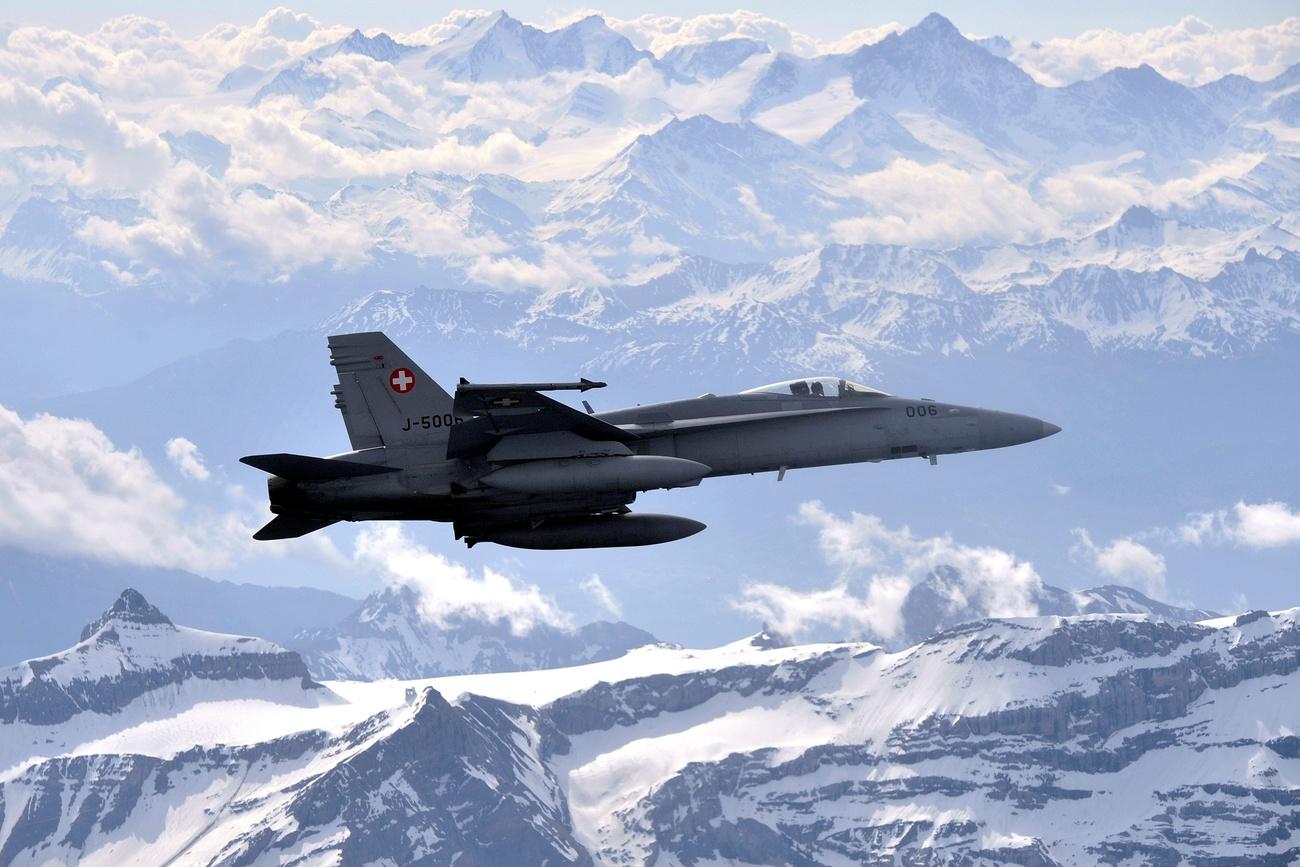 Fighter jet of the Swiss air force in mid flight over the Alps