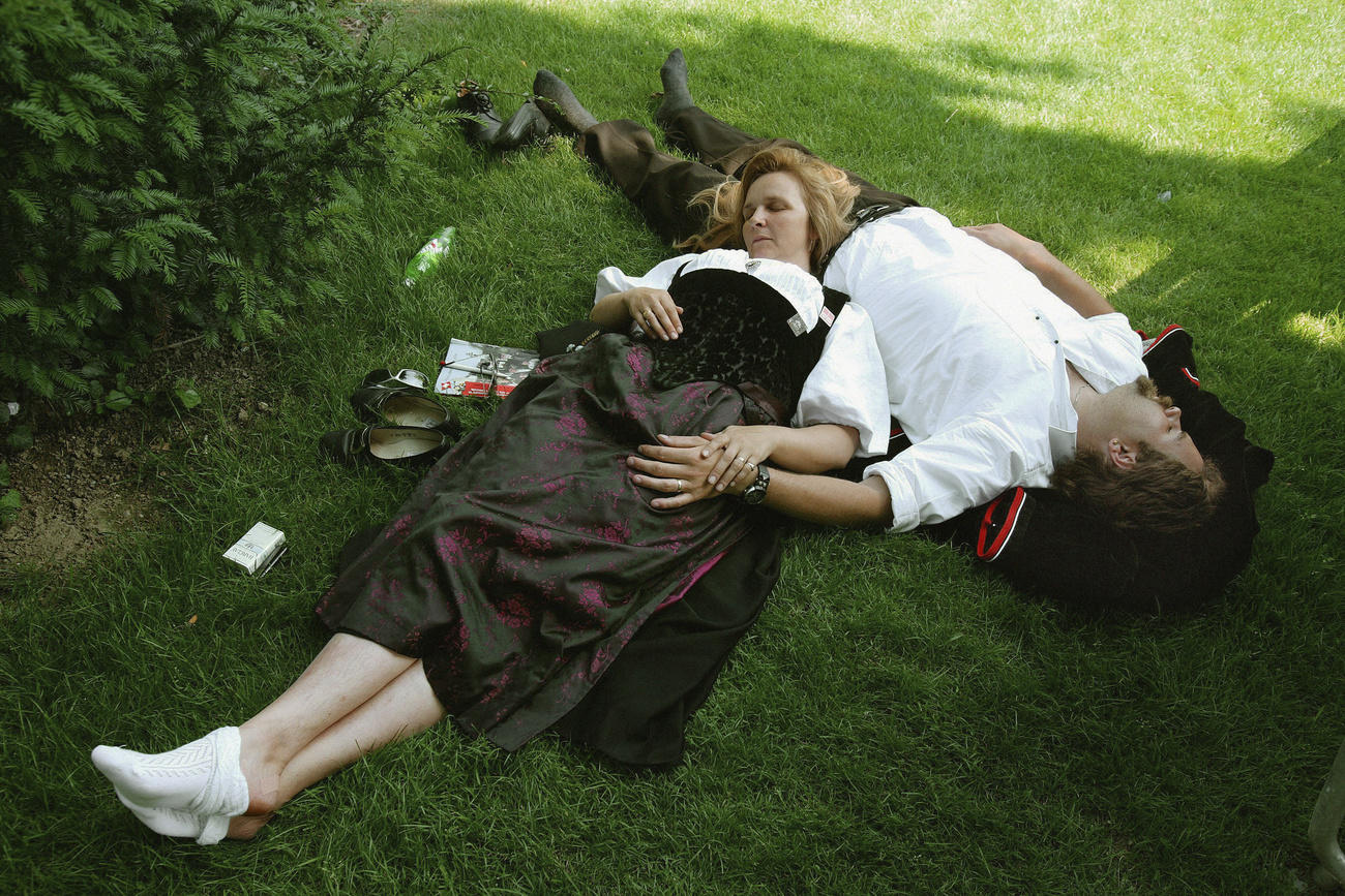 A couple sleeping on the grass