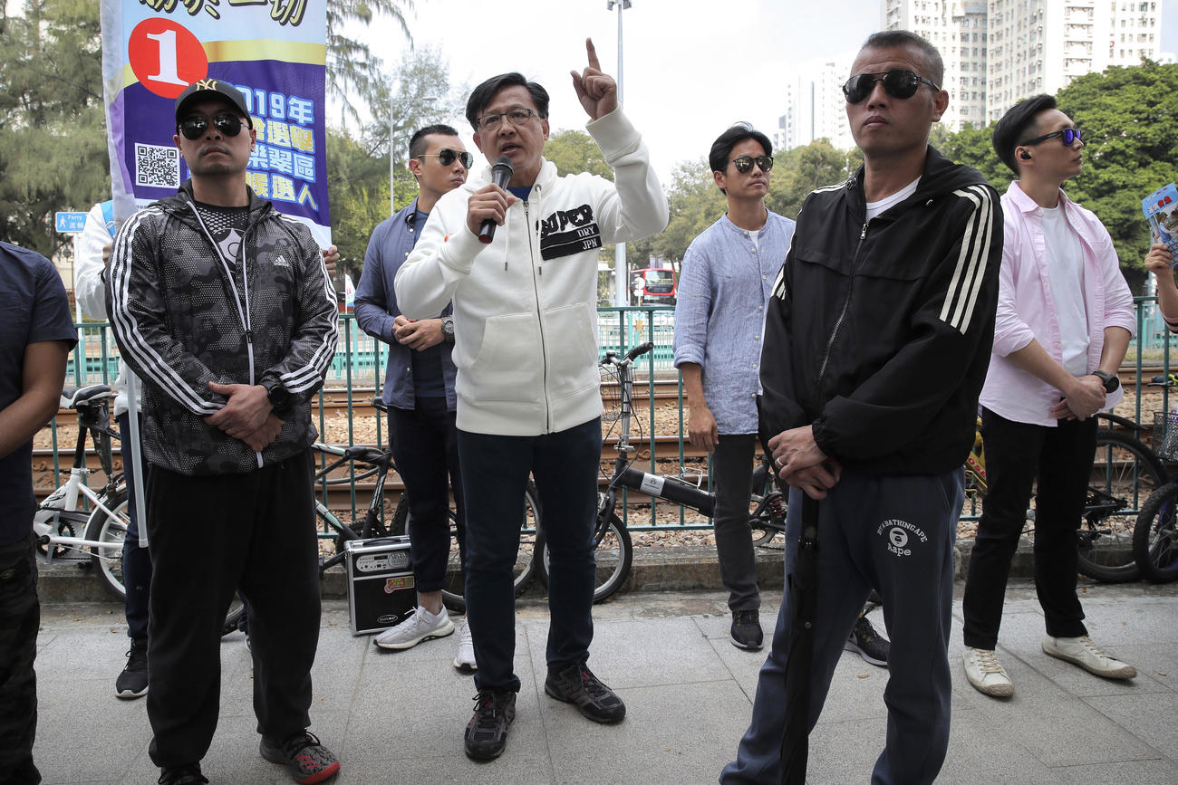 一位建制派候选人在保镖的保护下发表街头竞选演说。