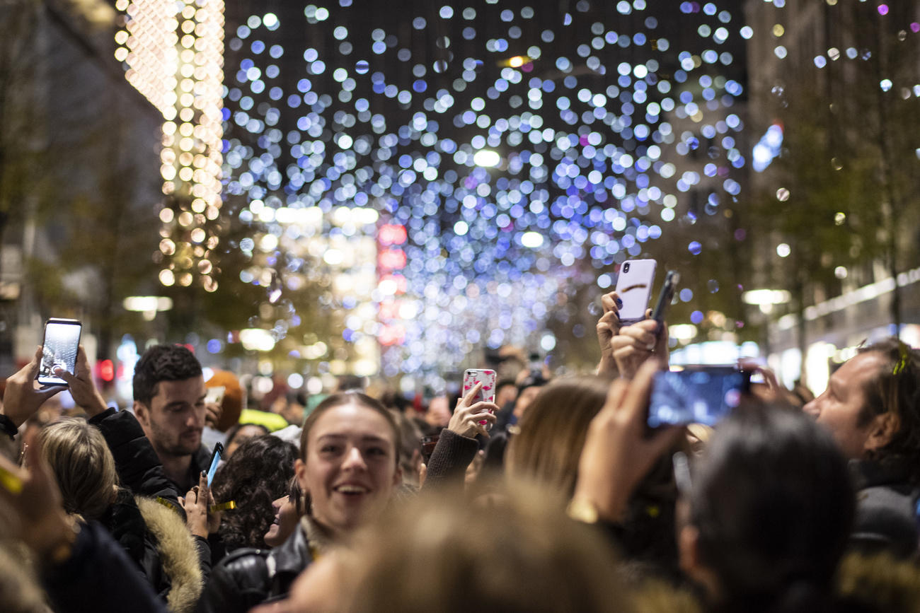 People taking pictures of the christmas lights