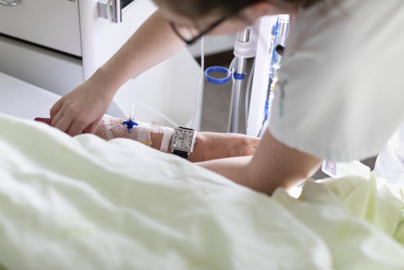 A nurse tending to a patient