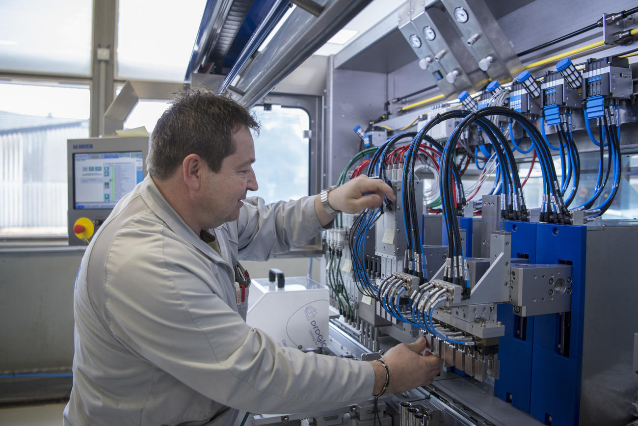 Employee working on assembly cell of a testing system.